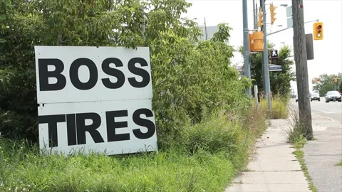 Boss tires writing caption text square sign on grass with sidewalk traffic light Stock Footage 249102513