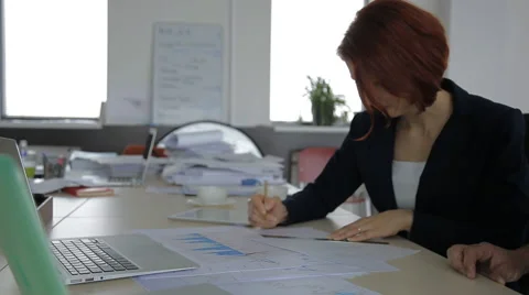 Boss using the office talking on the phone and his secretary working hard 스톡 동영상 58033719