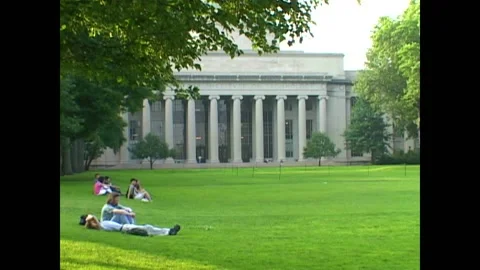 BOSTON - 1999 - Students rest outside an MIT building that has the school's name Stock Footage 284462996