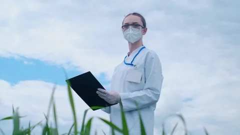 Botanist scientist analyzing plant crop making notes in a journal. Woman gardene Stock Footage 241801357