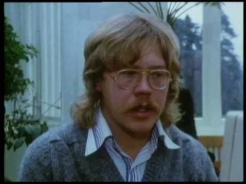 Botanist talking to IT man inside greenhouse about technology and job, 1985 Stock Footage 136675536