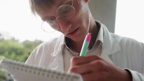 Botany Student in White Coat Focused on Writing Notes Stock Footage 321115103