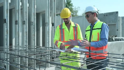 Both of construction engineers verify the constructed precast concrete wall Stock Footage 255349631