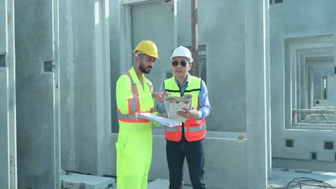 Both of construction engineers verify the constructed precast concrete wall Video stock 255350102