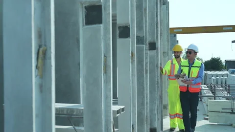 Both of construction engineers verify the constructed precast concrete wall Stock Footage 255350424