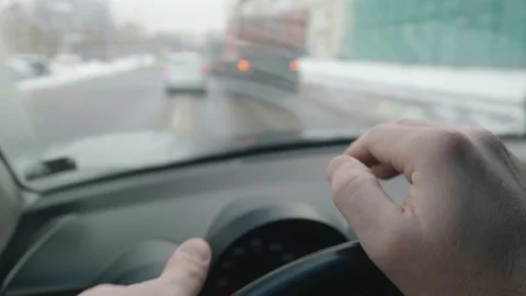 Both driver's hands are on steering wheel while driving. Car approaches Stock Footage 124535473