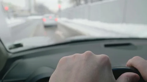 Both driver's hands are on steering wheel while driving. Car approaches Stock Footage 124535512
