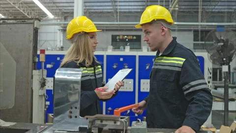 Both of engineer workers working on a machine in a factory Stock Footage 252896832