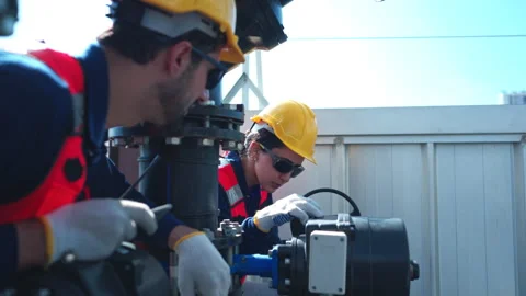 Both of engineers inspecting industrial pipeline and valve systems 스톡 동영상 339644729