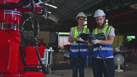 Both of engineers installing and testing a large robotic arm. Stock Footage 254548414