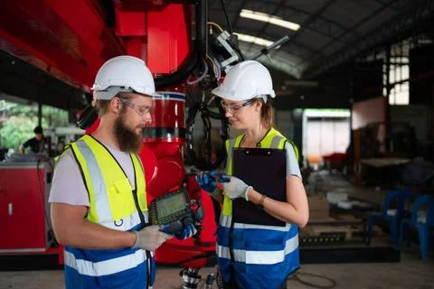 Both of engineers installing and testing a large robotic arm. before sendi... 写真素材