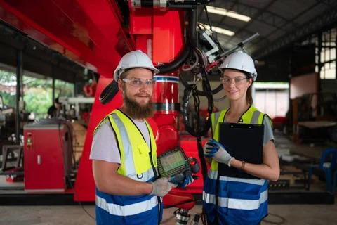 Both of engineers installing and testing a large robotic arm. before sendi... 写真素材