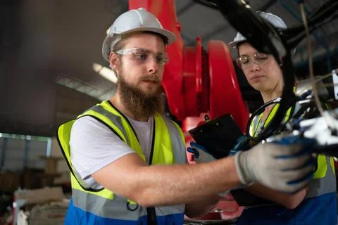 Both of engineers installing and testing a large robotic arm. before sendi... 写真素材