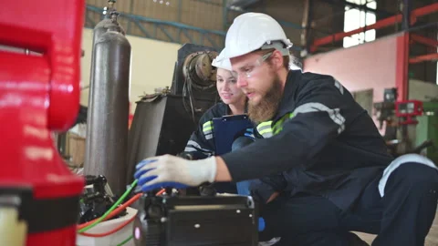 Both of engineers installing a small robotic arm is being installed for testing Stock Footage 254545317