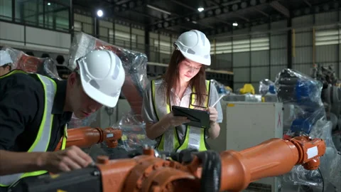 Both of engineers working together in a robotic arm factory Stock Footage 262753350