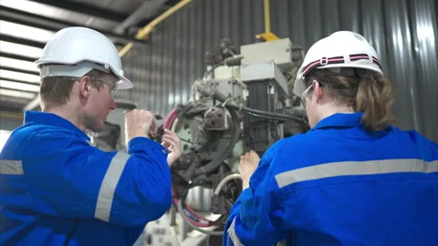 Both of engineers working together in a robotic arm factory Stock Footage 262757944