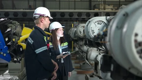 Both of engineers working together in a robotic arm factory Stock Footage 262762259