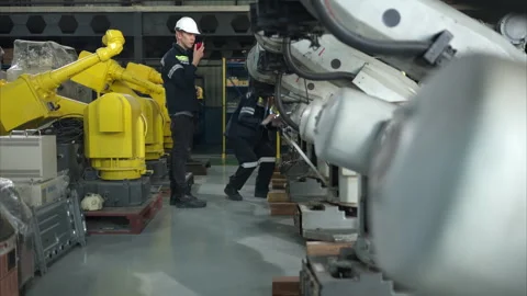 Both of engineers working together in a robotic arm factory, Stock Footage 262764089
