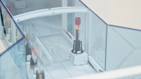 Both full and empty test tubes moving one after another in an automated lab. Lab Stock Footage 232489158