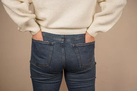 Both hands are casually placed in the pockets of the pants, giving off a sense Stock Photos