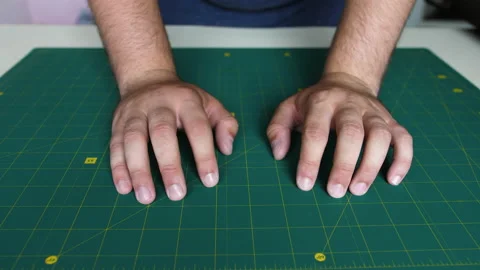 Both hands are on the table. The man crippled his hands on the table and knocked Stock Footage 198495661