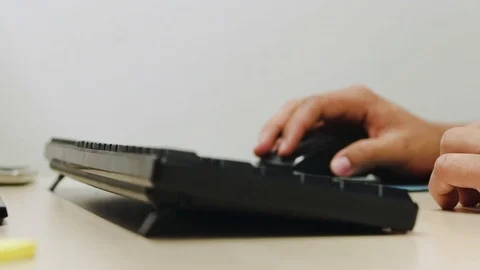 Both hands are working with keyboard and mouse in the office Stock Footage 95661952