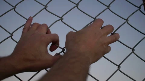 Both Hands Grabbing Chain Link Fence 動画素材 58146275