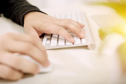 Both hands on the keyboard and mouse Stock Photos