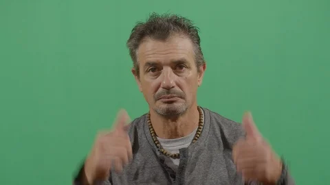 Both hands saying ok to the camera like something good happened or trying to Stock Footage 115340307