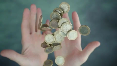 Both hands throwing up pile of Euro coins over green table Video stock 165946018