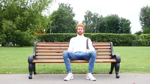 Both Hands Thumbs Up by Man Sitting on Bench in Park, Red Hairs and Beard Stock Footage