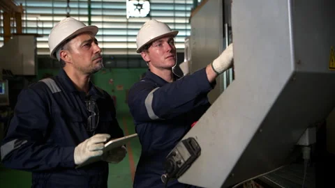 Both of industrial engineer stands in front of a control panel Stock Footage 339201605