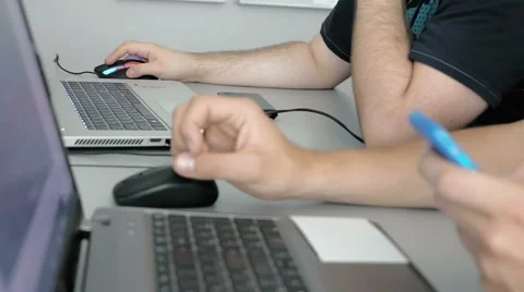 Both males are focused on their work in team Stock Footage 65219848