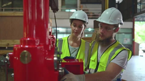 Both of mechanical engineers are checking the working condition Stock Footage 254546709