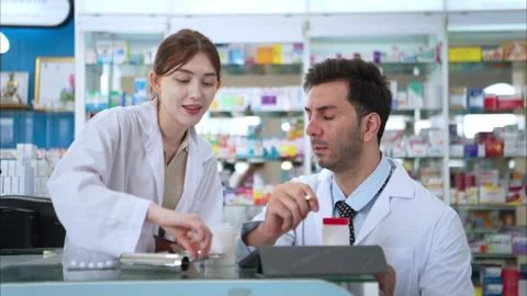 Both of Pharmacist doing antibiotic trials and testing the medicine Stock Footage 308359694
