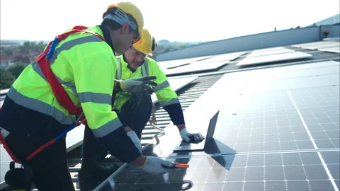 Both of technicians is installing solar panels on the roof of the warehouse Stock Footage 260157873