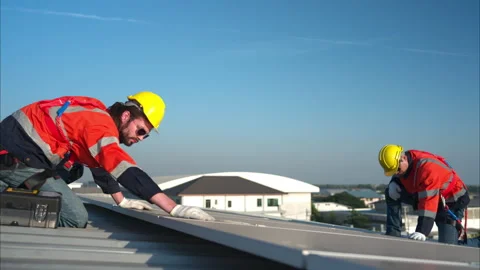 Both of technicians is installing solar panels on the roof of the warehouse Stock Footage 260161013