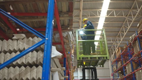 Both of warehouse staff working together in basket of forklift Stock Footage 252899344