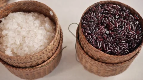 Both white and black sticky rice are served in woven bamboo containers Stock Footage 310936002