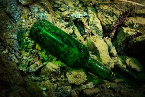 Botle in a river Stock Photos