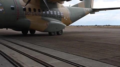 Botswana Defence Force CASA CN-235 aircraft reversing out of hangar Stock Footage 279551996