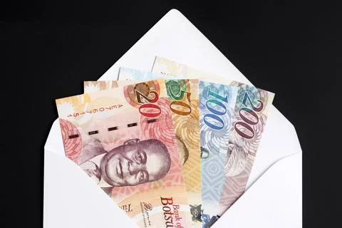 Botswana pula in a white envelope on a black background Stock Photos