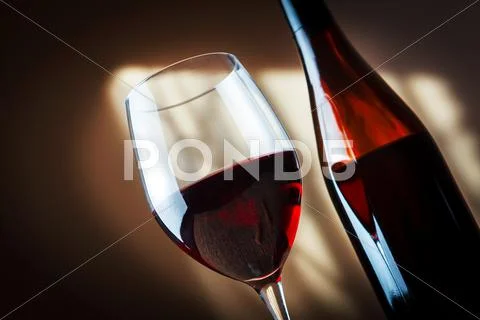 Bottle and glass of red wine Stock Photos