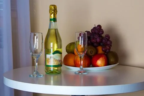 Bottle and glasses on the table Stock Photos