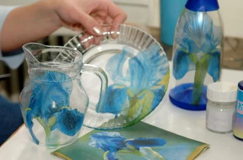 Bottle and hands with a plate Stock Photos