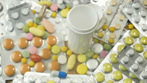 Bottle and large group of assorted capsules, pills, tablets and blisters, bac Stock Footage 156742991
