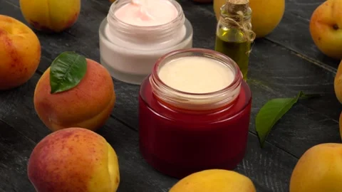 Bottle with apricot kernel oil and jars with cosmetic cream Stock Footage 278038685
