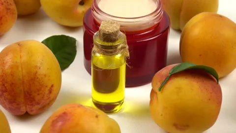 Bottle with apricot kernel oil and jar with cosmetic cream Stock Footage 278038720