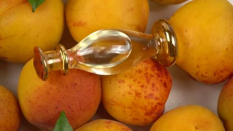 Bottle with apricot kernel oil placed on the fresh apricot fruit, background Stock Footage 278038788