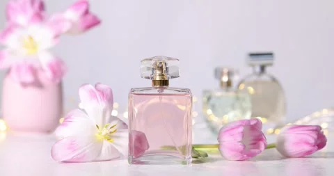 Bottle of aromatic perfume and beautiful tulips on white table Stock-Footage 305004813